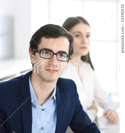 Group of business people discussing questions at meeting in modern office. Headshot of businessman 59398818