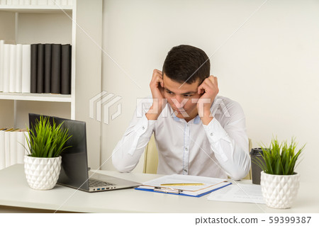 Serious frustrated asian businessman suffering 59399387