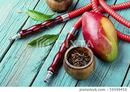 Smoking hookah with mango 59399450