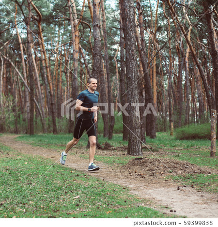 Man runner run in the outdoor pine forest Man runner run in the outdoor pine forest 59399838