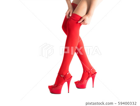 Sexy female legs in fetish red stockings and high heels, isolated on white, woman pulls up her hose. 59400332