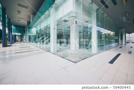 Modern empty office buildings with glass wall and empty pavement . 59400445