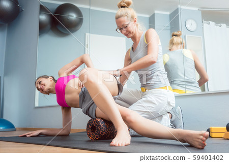 Woman stretching and relaxing in physical therapy exercise Woman stretching and relaxing in physical therapy exercise 59401402