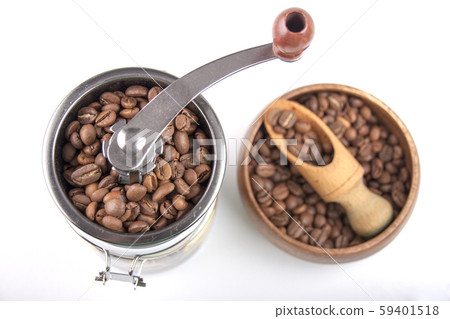 Coffee beans in a coffee grinder and a wooden bowl 59401518