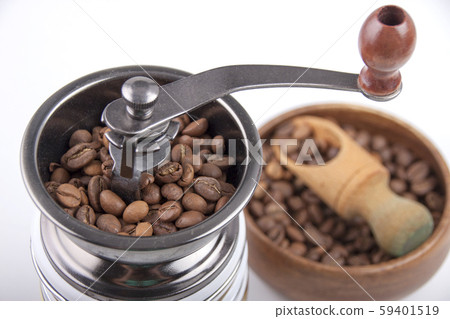 Coffee beans in a coffee grinder and a wooden bowl Coffee beans in a coffee grinder and a wooden bowl 59401519