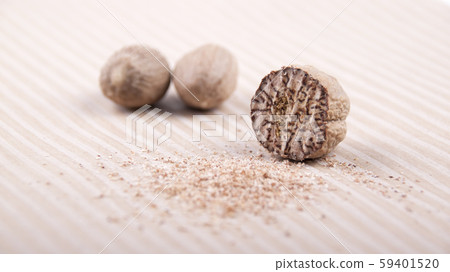 Grated nutmeg on a striped surface Grated nutmeg on a striped surface 59401520