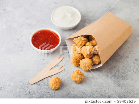 Crunchy southern chicken popcorn bites in paper Crunchy southern chicken popcorn bites in paper 59402629