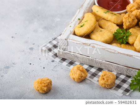 Buttered chicken nuggets and popcorn bites in 59402631
