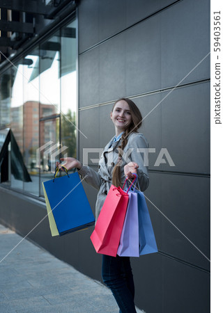 Happy young woman shopaholic with colorful bags 59403561