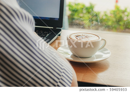 Freelancer working in cafe on a wooden counter bar Freelancer working in cafe on a wooden counter bar 59405933