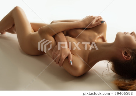 Nude girl embracing herself high angle shot 59406598