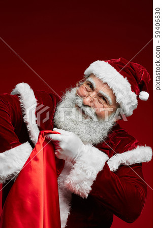 Smiling Santa Claus Holding Sack with Presents 59406830