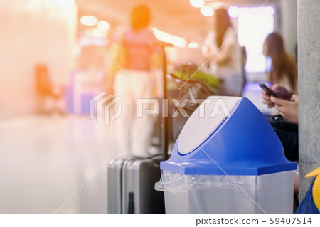 Blue cover transparent trashcan for increasing safety measures placed on the floor in the airport. Blue cover transparent trashcan for increasing safety measures placed on the floor in the airport. 59407514