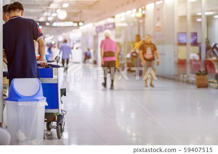 Blue cover transparent trashcan for increasing safety measures placed on the floor in the airport. Blue cover transparent trashcan for increasing safety measures placed on the floor in the airport. 59407515