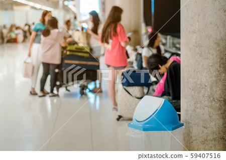Blue cover transparent trashcan for increasing safety measures placed on the floor in the airport. Blue cover transparent trashcan for increasing safety measures placed on the floor in the airport. 59407516