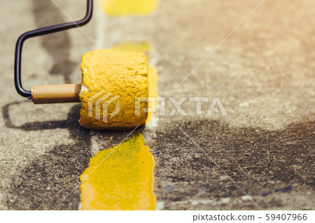 Male students use small paint rollers to paint yellow lines on the cement floor for Sepak Takraw training 59407966