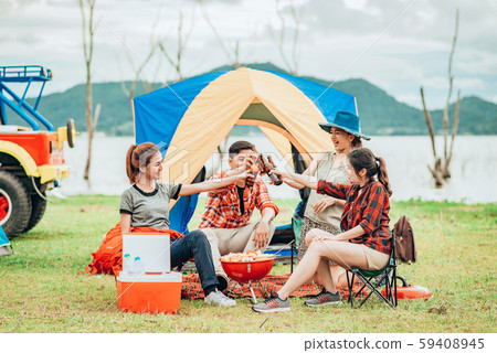 Group of friends having barbecue and clinking Group of friends having barbecue and clinking 59408945