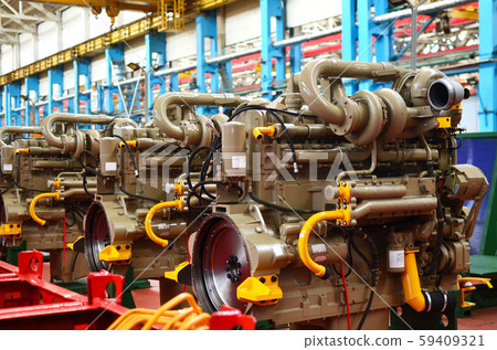 Diesel engines with huge turbines on assembly line in the workshop of the factory 59409321