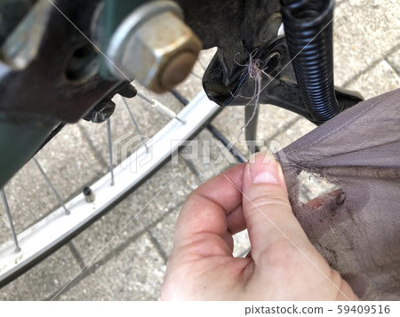 Skirt that was torn between the parts of a bicycle Skirt that was torn between the parts of a bicycle 59409516