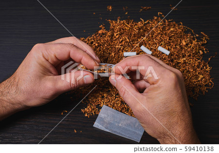 man makes a cigarette man makes a cigarette 59410138