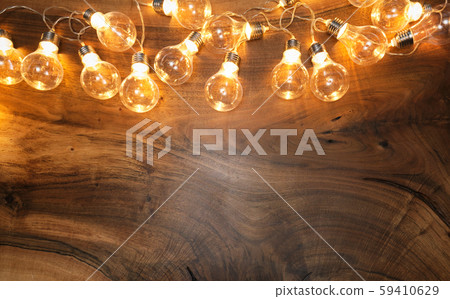 Light bulbs on brown wooden background 59410629