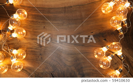 Light bulbs on brown wooden background Light bulbs on brown wooden background 59410630