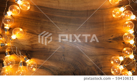 Light bulbs on brown wooden background 59410631