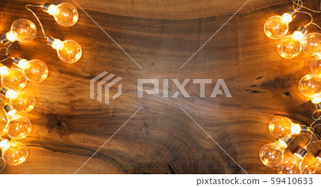 Light bulbs on brown wooden background 59410633