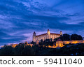 Bratislava castle illuminated in evening glow against dramatic sky 59411040