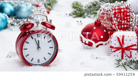 Red vintage alarm clock in the snow 59411259