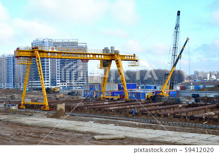 Gantry crane and auto crane working at construction site Gantry crane and auto crane working at construction site 59412020