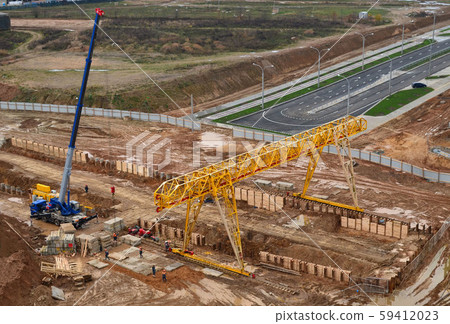 Gantry crane and auto crane working at construction site Gantry crane and auto crane working at construction site 59412023