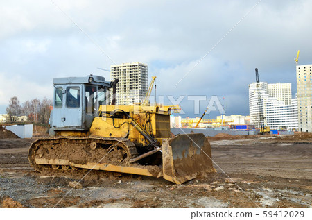 Bulldozer during of large construction jobs at building site Bulldozer during of large construction jobs at building site 59412029