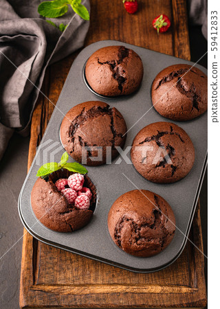 Chocolate muffins in metal muffin baking tin 59412833