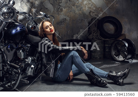 Young woman with motorcycle studio Young woman with motorcycle studio 59413560