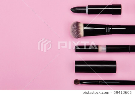 Set of brushes and cosmetic products on a pink background Set of brushes and cosmetic products on a pink background 59413605