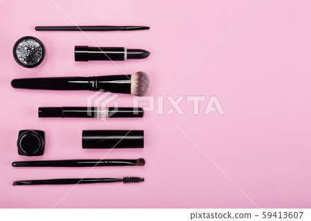 Set of brushes and cosmetic products on a pink background Set of brushes and cosmetic products on a pink background 59413607