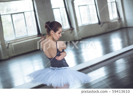 Young ballet dancer looking down in studio active lifestyle Young ballet dancer looking down in studio active lifestyle 59413610