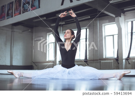 Young ballet dancer practice twine in studio active lifestyle Young ballet dancer practice twine in studio active lifestyle 59413694