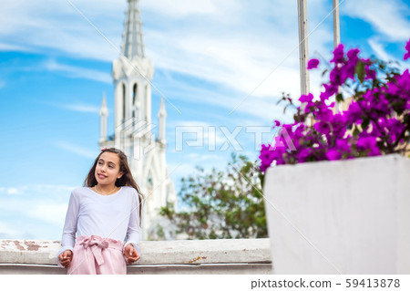 Girl on the Ortiz Bridge with the gothic church of La Ermita built on 1602 in the city of Cali Girl on the Ortiz Bridge with the gothic church of La Ermita built on 1602 in the city of Cali 59413878