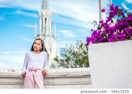Girl on the Ortiz Bridge with the gothic church of La Ermita built on 1602 in the city of Cali Girl on the Ortiz Bridge with the gothic church of La Ermita built on 1602 in the city of Cali 59413879
