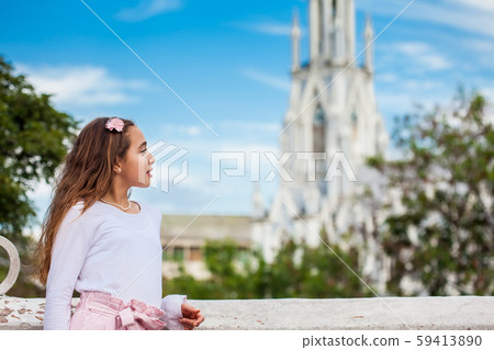 Girl on the Ortiz Bridge looking at the famous gothic church of La Ermita built on 1602 in Cali 59413890