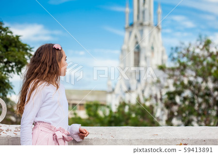 Girl on the Ortiz Bridge looking at the famous gothic church of La Ermita built on 1602 in Cali Girl on the Ortiz Bridge looking at the famous gothic church of La Ermita built on 1602 in Cali 59413891