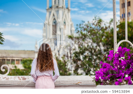 Girl on the Ortiz Bridge looking at the famous gothic church of La Ermita built on 1602 in Cali Girl on the Ortiz Bridge looking at the famous gothic church of La Ermita built on 1602 in Cali 59413894