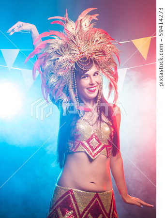 Holidays, party, dance and nightlife concept - Beautiful woman dressed for carnival night 59414273