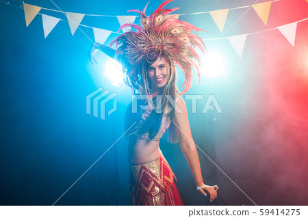 Holidays, party, dance and nightlife concept - Beautiful woman dressed for carnival night 59414275