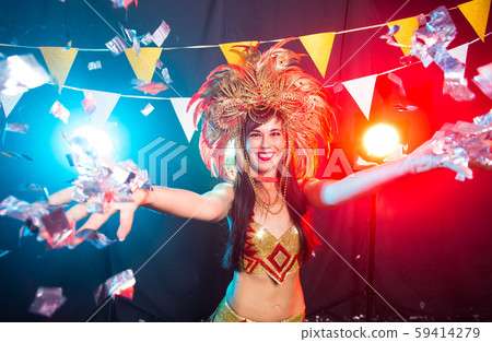Holidays, party, dance and nightlife concept - Beautiful woman dressed for carnival night 59414279