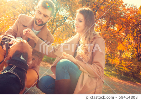 Young couple walk in the autumn park Young couple walk in the autumn park 59414808