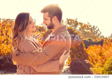 Young couple walk in the autumn park Young couple walk in the autumn park 59414907