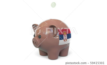 Putting money into piggy bank with flag of Serbia. Tax system system or savings related conceptual Putting money into piggy bank with flag of Serbia. Tax system system or savings related conceptual 59415301
